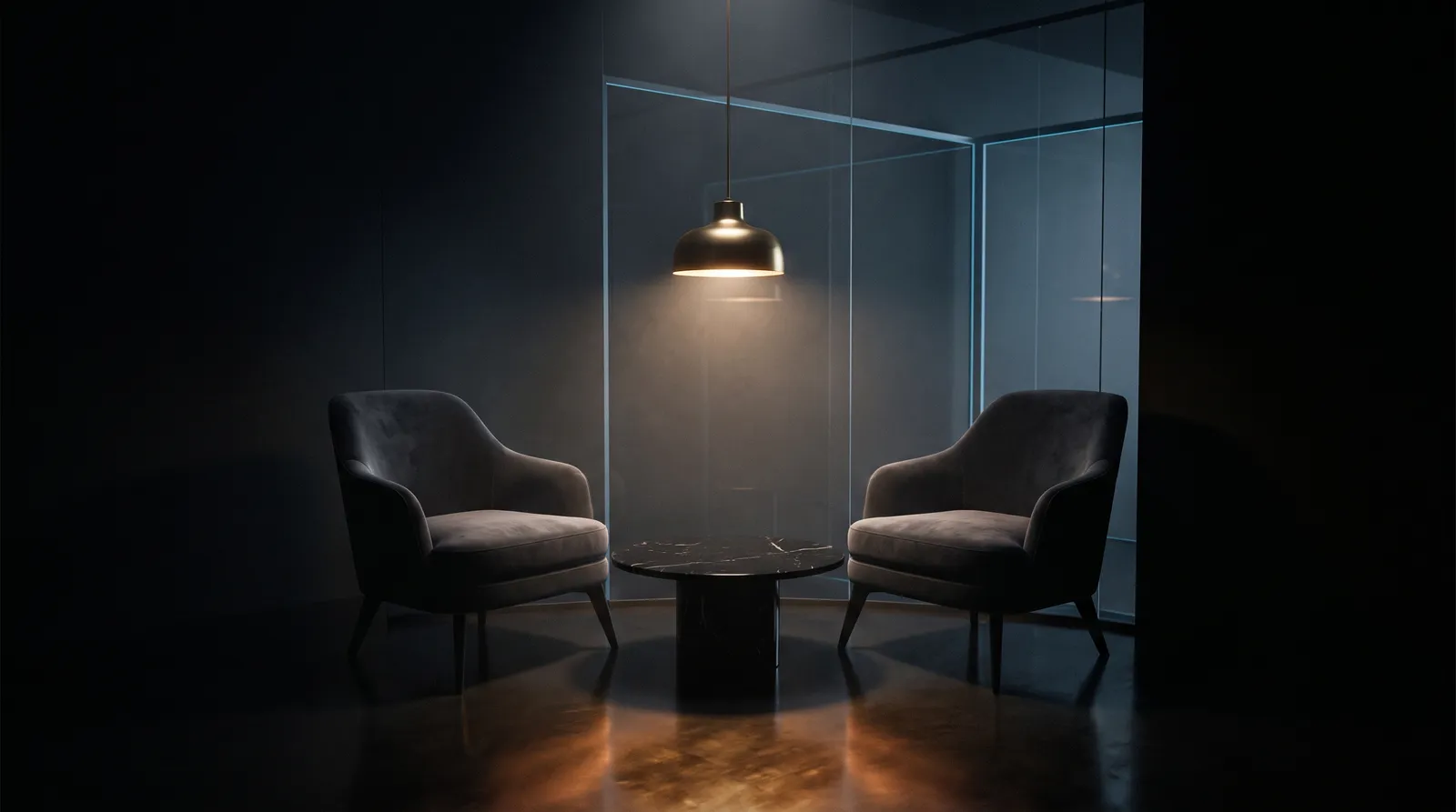 Two armchairs facing each other in a softly lit consultation corner of a dark clinic