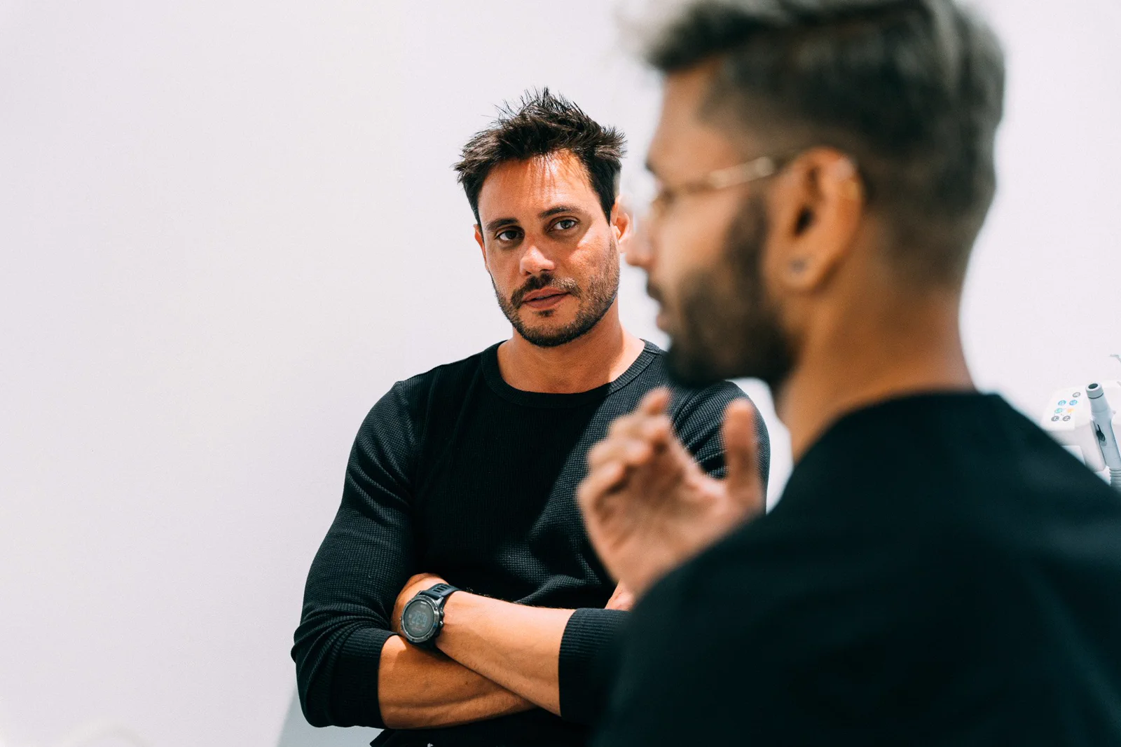 Two dental clinicians exchange ideas in a bright treatment space.